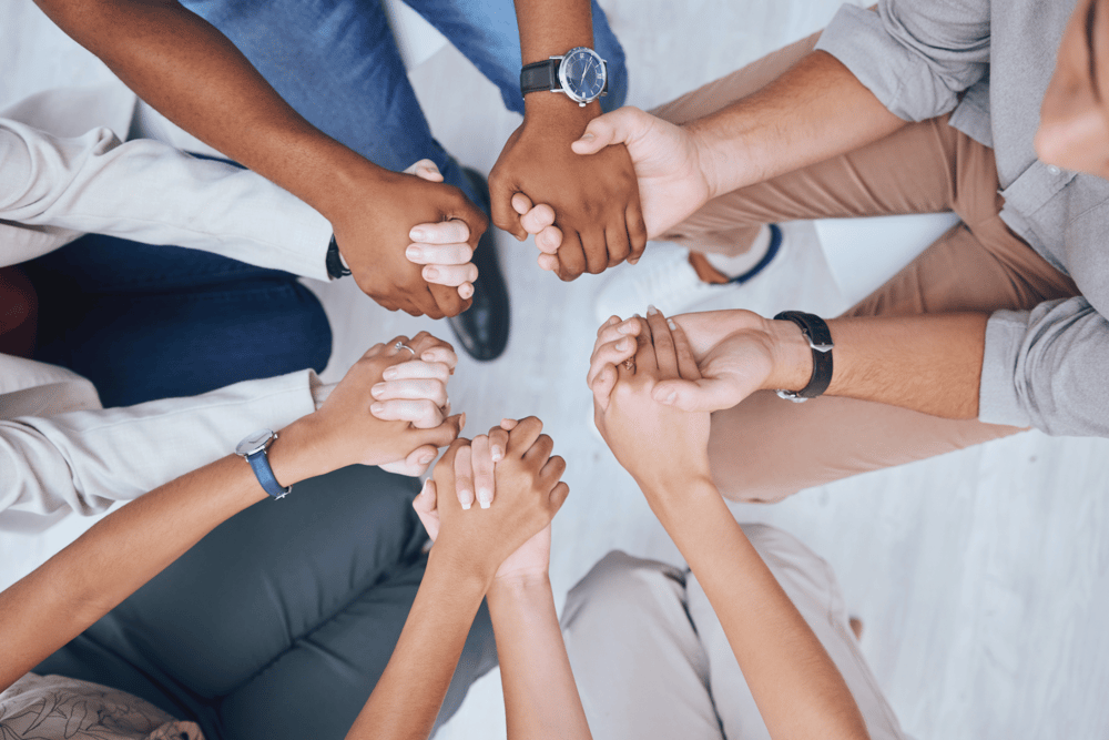 group-hand-holding_528837215-min