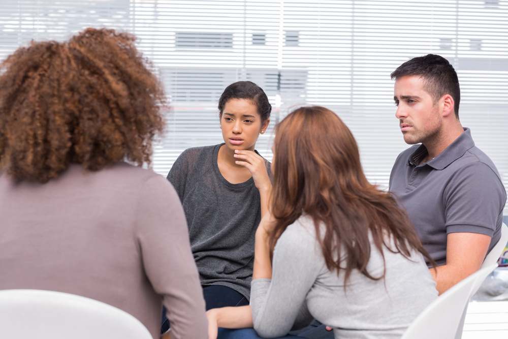 Patients listening to another patient during therapy session